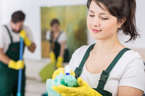 Cleaner Mayfair worker following safe cleaning procedures