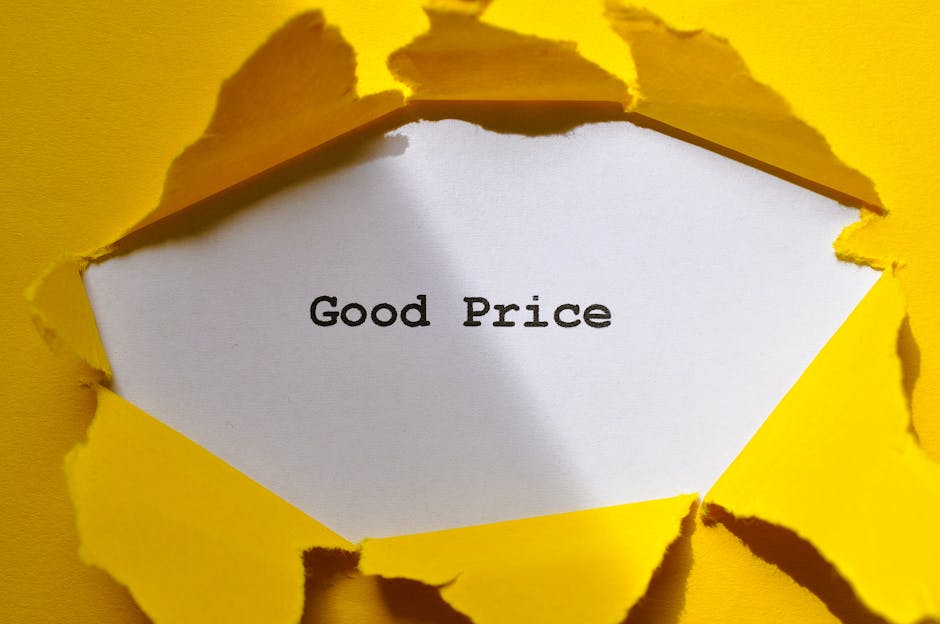 A piece of yellow torn paper revealing a white surface underneath with the words 'Good Price' printed in black. The torn edges of the paper are uneven and curled, creating a textured border around the message. The background is solid yellow, emphasizing the contrast between the torn paper and the message, which relates to transparent pricing in cleaning services offered by Cleaner Mayfair. The image is well-lit, highlighting the torn paper's texture and the clarity of the text, suitable for illustrating topics about cleaning cost clarity and honest pricing.